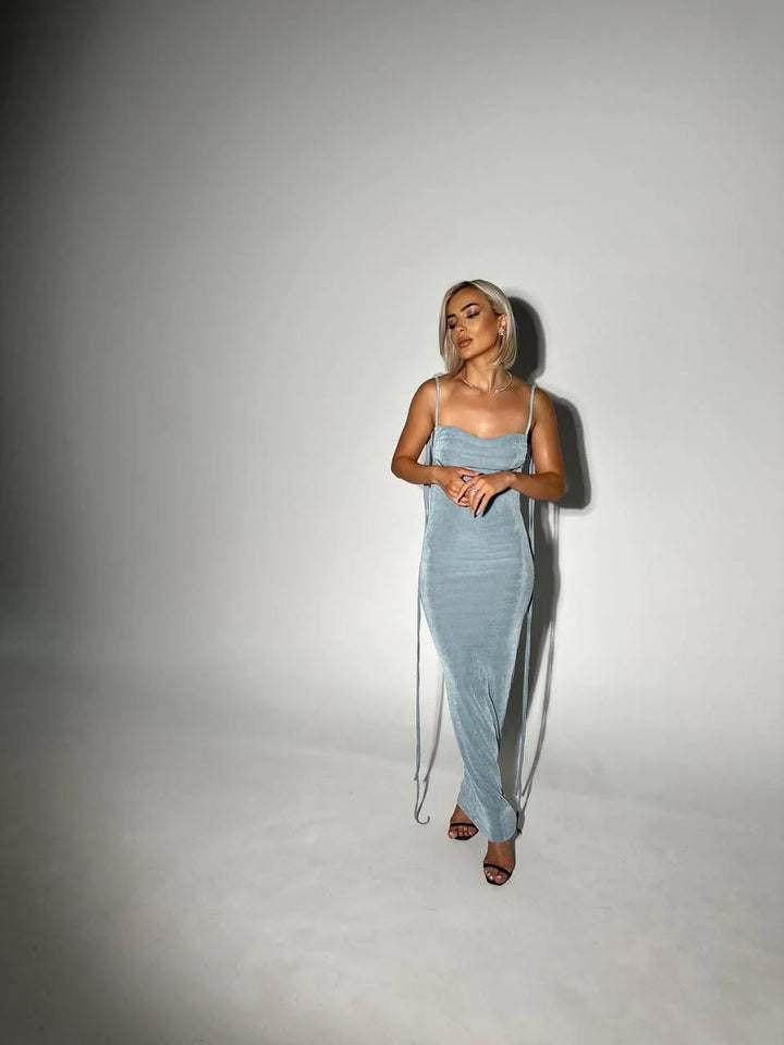 Alt text: Aaira backless dress in lightweight fabric with adjustable ties for a sleek look.