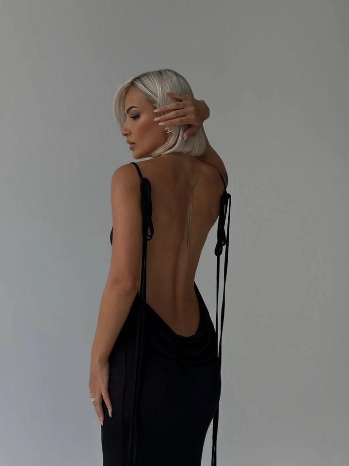 Alt text: "Aaira backless dress with adjustable ties, showcasing a sleek and modern design for effortless chic style."