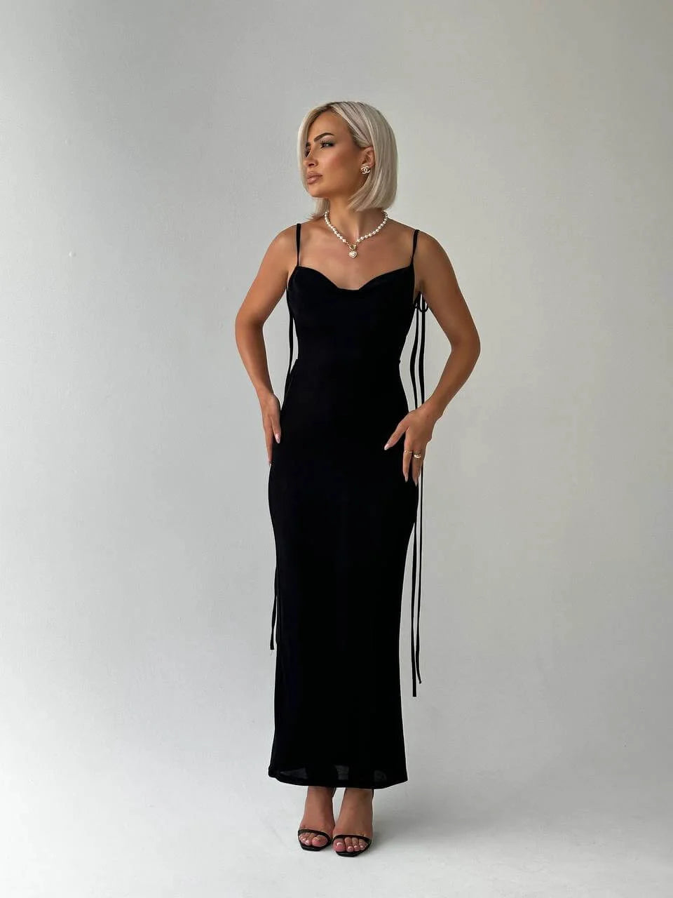 Backless top in black made from soft cotton blend with adjustable ties for a stylish look.