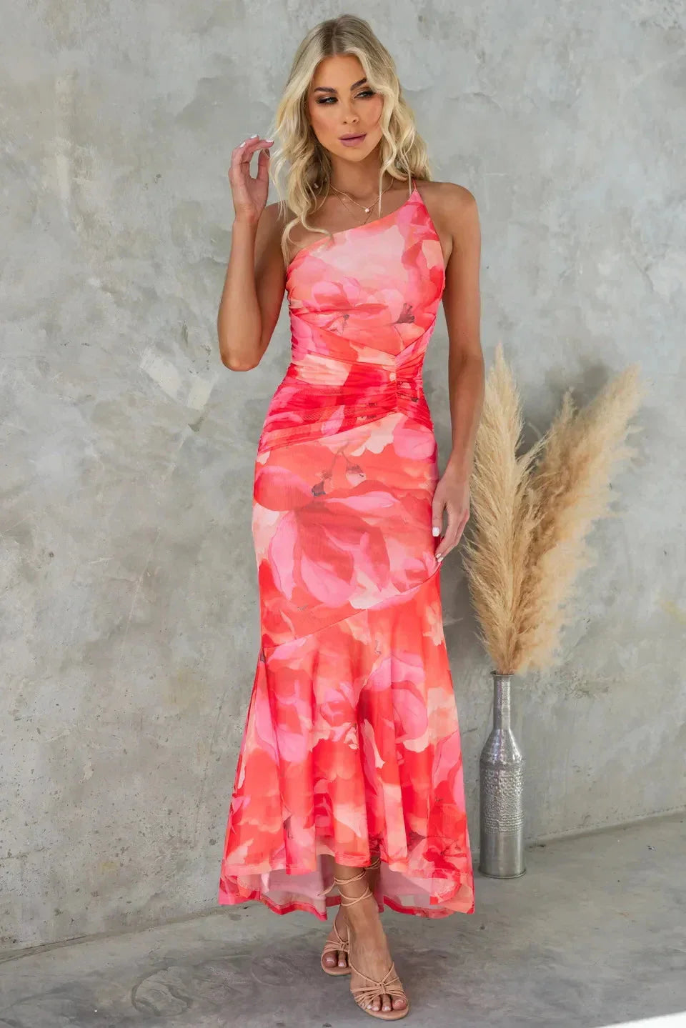 Red strapless floral maxi dress with asymmetrical hem, made of flowing chiffon fabric. Perfect for a romantic evening out or…