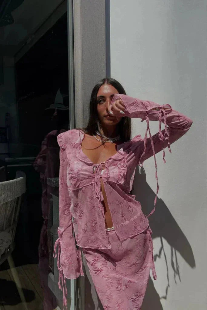 Pink ruffled blouse and maxi skirt set, perfect for a casual chic look. Made of soft, flowy fabric with delicate ruffles.
