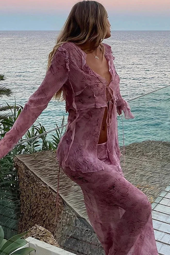 Pink ruffled blouse and maxi skirt set, featuring feminine design with delicate details, perfect for a chic and elegant look.