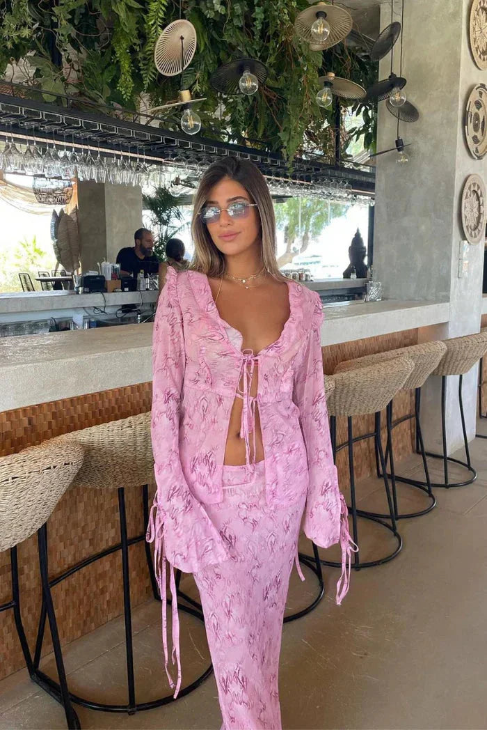 "Abrianna two-piece set featuring a ruffled pink blouse and flowy maxi skirt in soft, lightweight fabric."