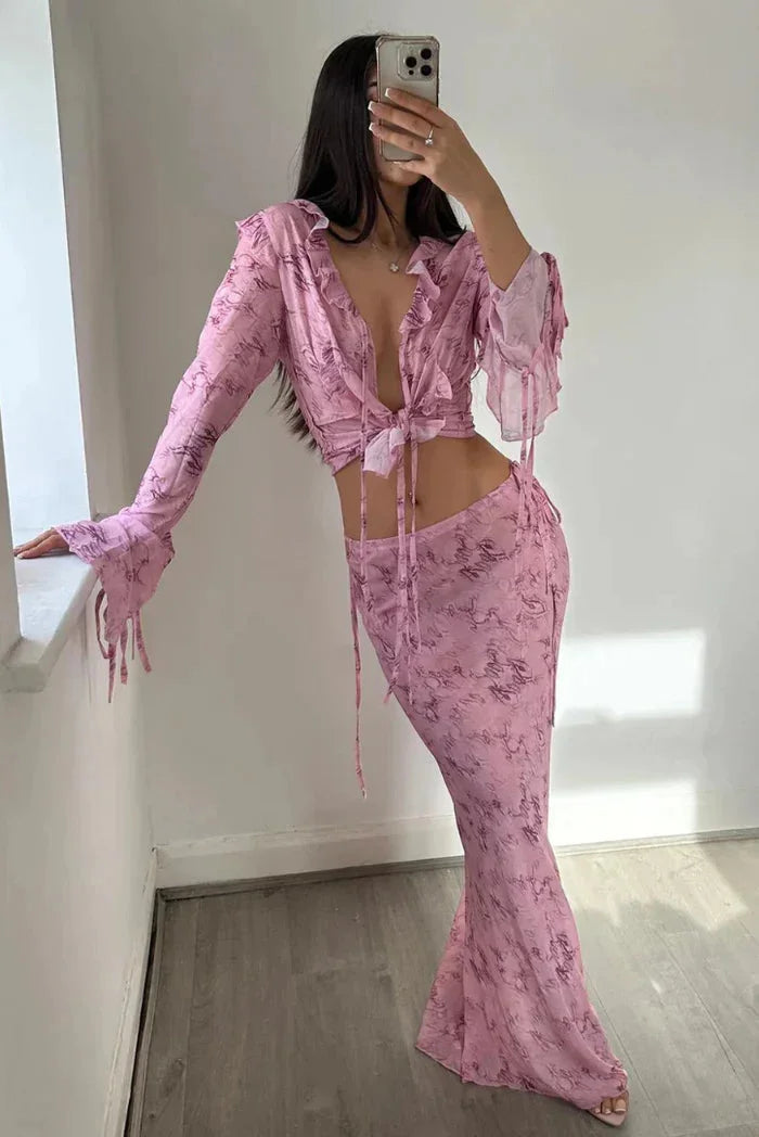 Pink ruffled blouse and maxi skirt set in flowy chiffon fabric. Delicate ruffles add elegance to this two-piece outfit.