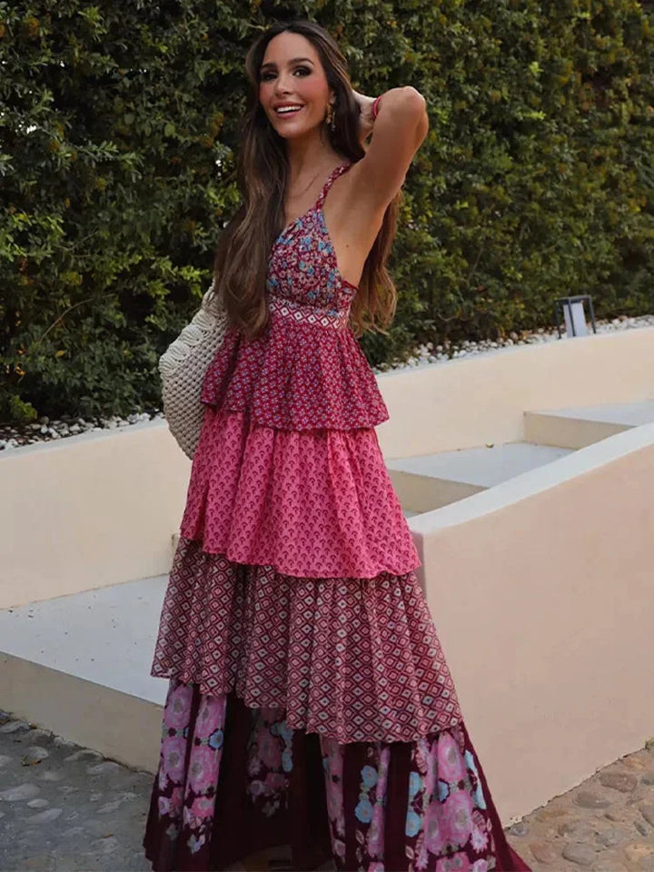 "Sleeveless red and pink multi-tier dress in a vibrant color combination with a flowing design, perfect for any casual…