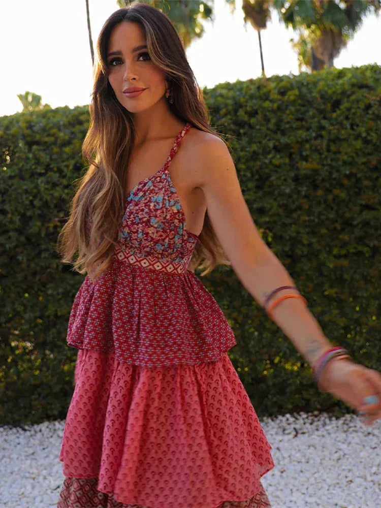Sleeveless red pink dress with multi-tier design in lightweight fabric.