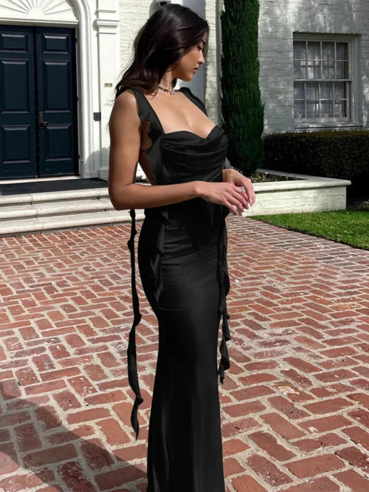 Navy blue satin midi dress with adjustable straps and sleek silhouette, perfect for evening events or special occasions.