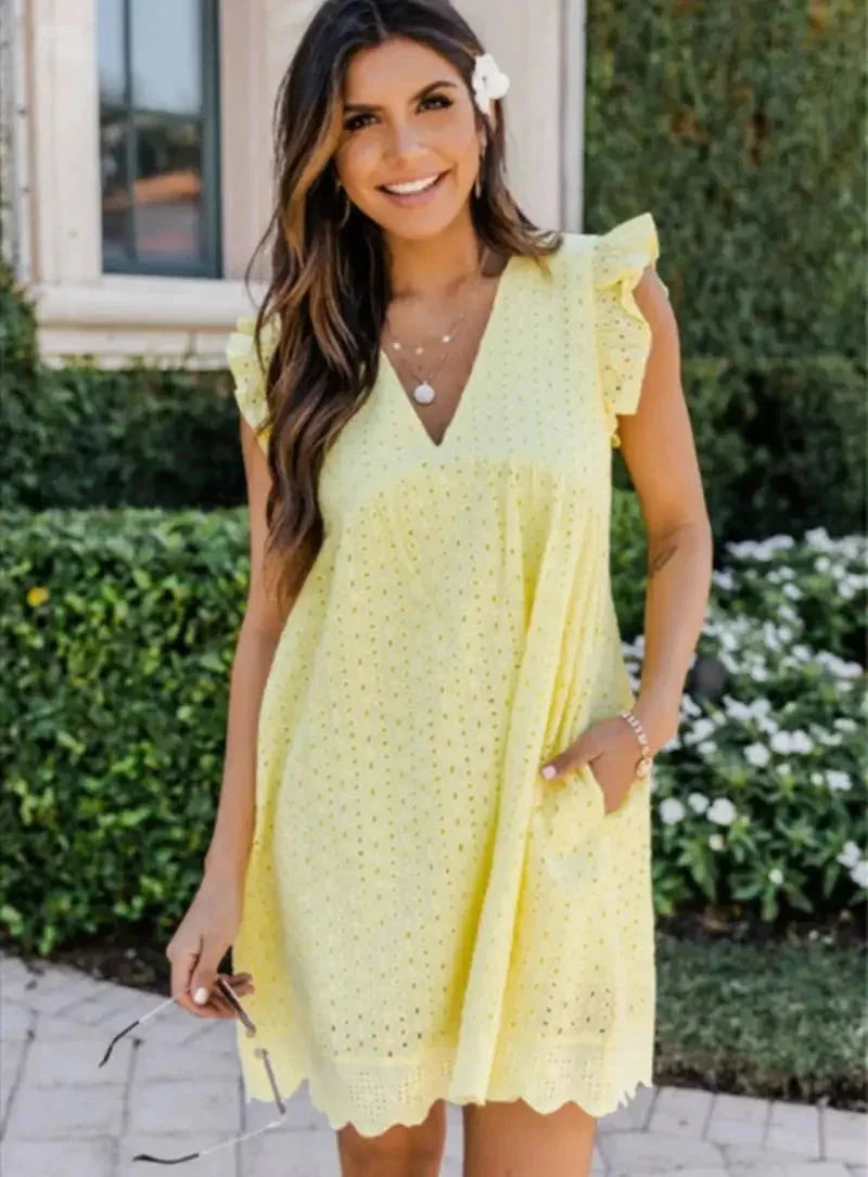 Yellow eyelet mini dress with V-neck in a flowy design. Perfect for a breezy day out.