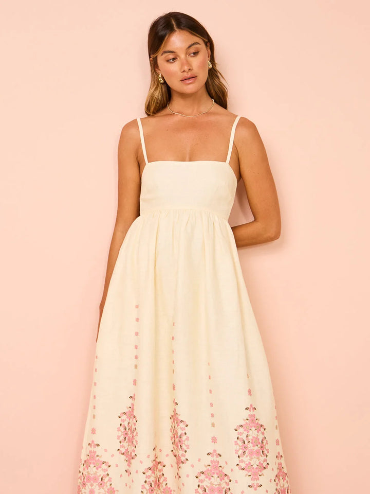 White summer dress with floral pattern and detailed hem in lightweight cotton fabric.