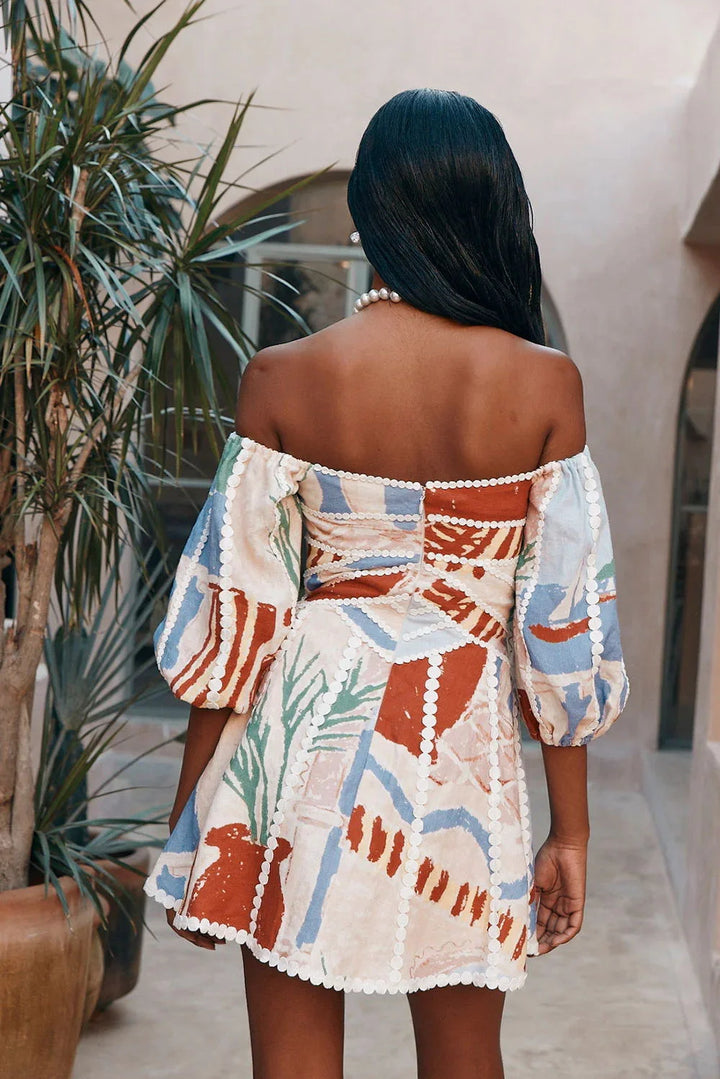 Off-shoulder white dress with delicate patterns, perfect for summer.