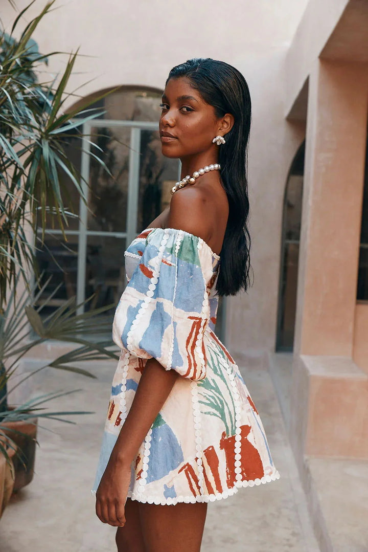 "White patterned off-shoulder dress for women, made of lightweight breathable fabric with modern design."