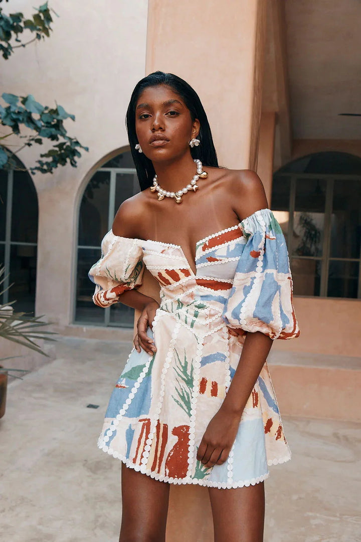 "White off-shoulder dress with elegant pattern, perfect for summer. Made with lightweight fabric, flattering fit."
