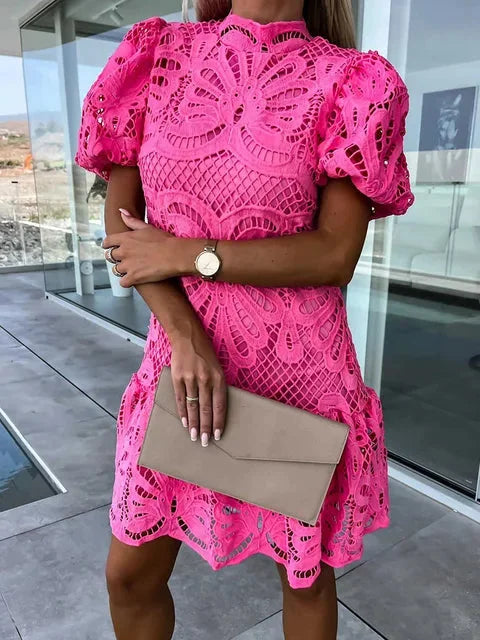 "Mini lace dress in Pink with elegant puff sleeves and intricate lace details, perfect for a stylish day out or special…