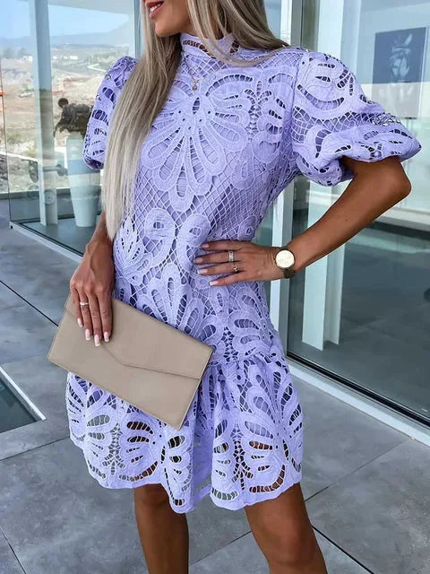 Purple mini lace dress with puff sleeves, delicate and elegant design, perfect for special occasions.