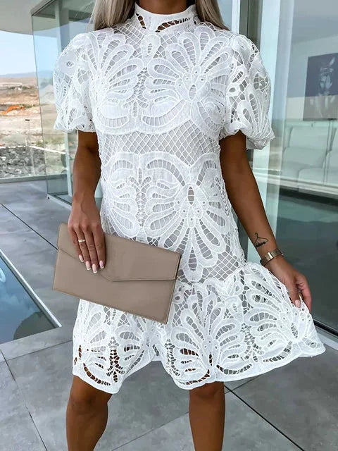 White lace mini dress with puff sleeves, elegant and feminine design.