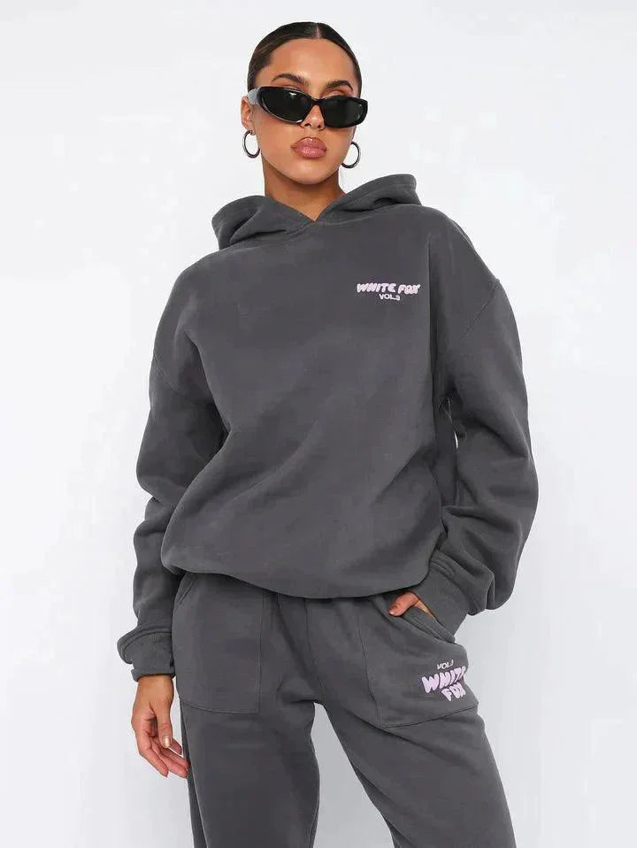 "Adelynne - Two-piece hoodie and pants set in soft, cozy fabric with a relaxed fit and drawstring waistband."