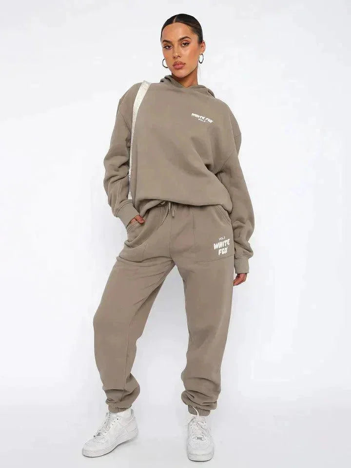 "Soothing two-piece loungewear set in a soft fabric, featuring a cozy hoodie and matching pants for comfortable relaxation."