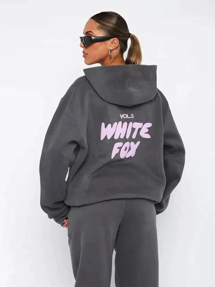 Dark grey two-piece hoodie and pants set made of soft, cozy fabric. Features a relaxed fit with a drawstring waist for…