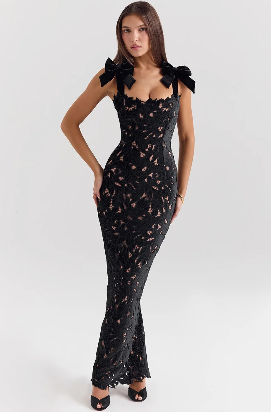 "Black lace maxi dress with delicate bows, perfect for a special occasion or evening event."