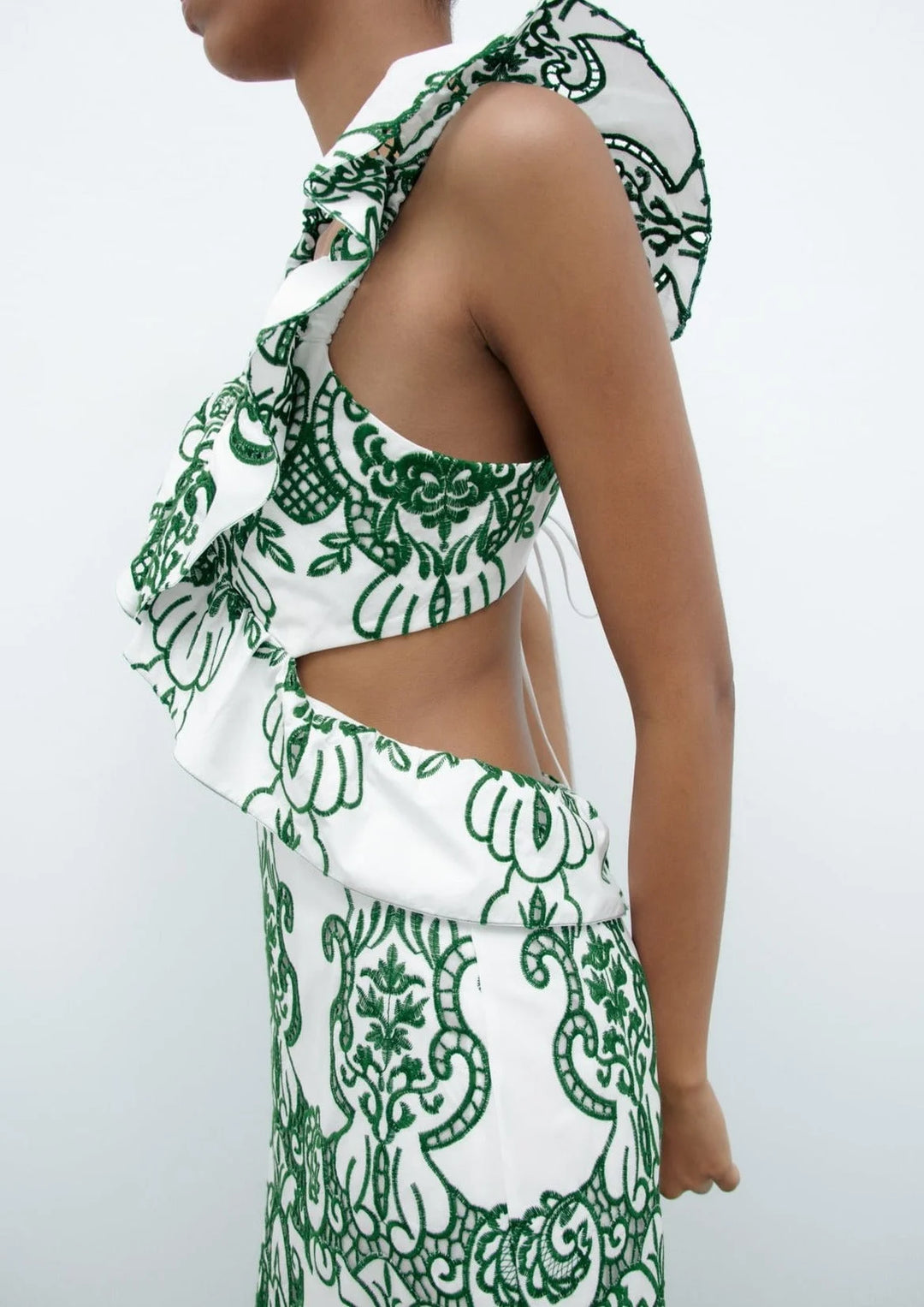 White and green maxi dress with ruffled details, perfect for a summery look, made from lightweight and breathable fabric.