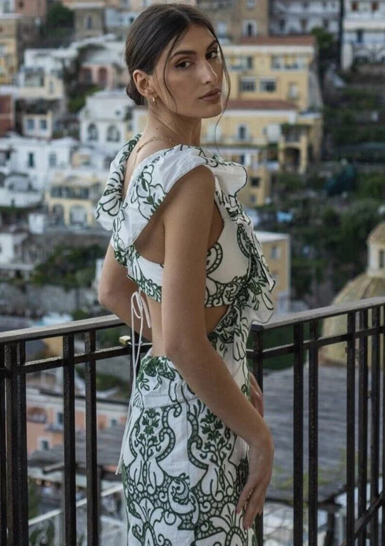 Ruffled white and green maxi dress with a flowy silhouette and delicate details, perfect for a breezy day out or an elegant…