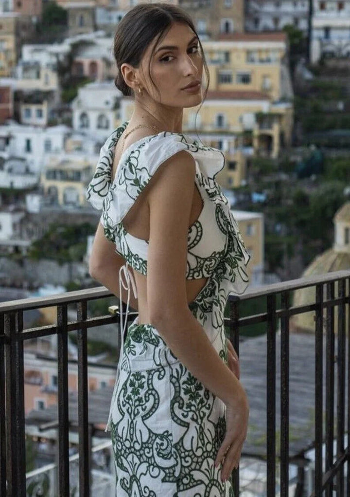 Ruffled white and green maxi dress with a flowy silhouette and delicate details, perfect for a breezy day out or an elegant…