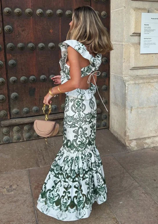 White and green ruffled maxi dress made from a flowy and airy fabric. Perfect for a chic and feminine summer look.