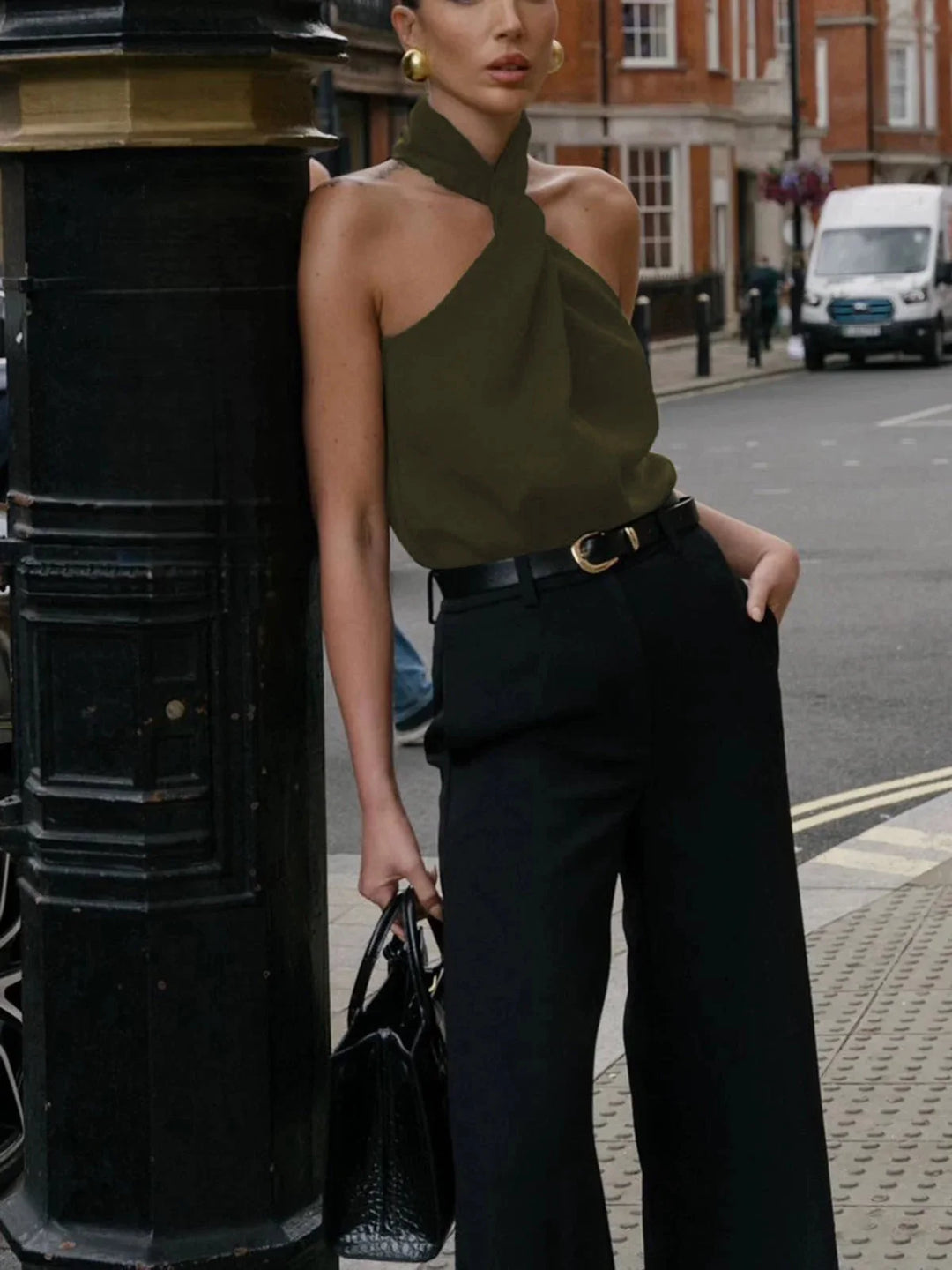 Armygreen sleeveless blouse with an asymmetric neck design. Made of high-quality fabric, perfect for a casual yet stylish…