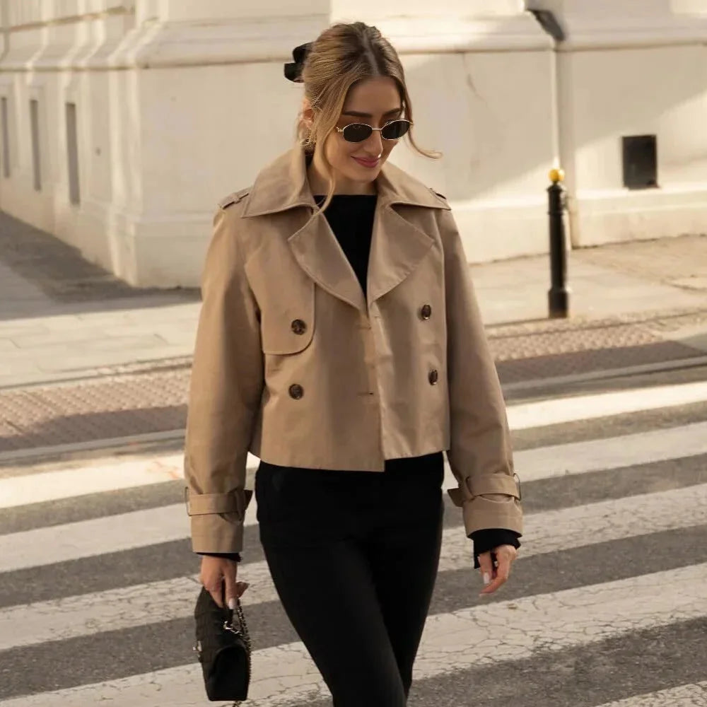 Navy blue double-breasted cropped jacket with peak lapels and golden buttons, perfect for any season.