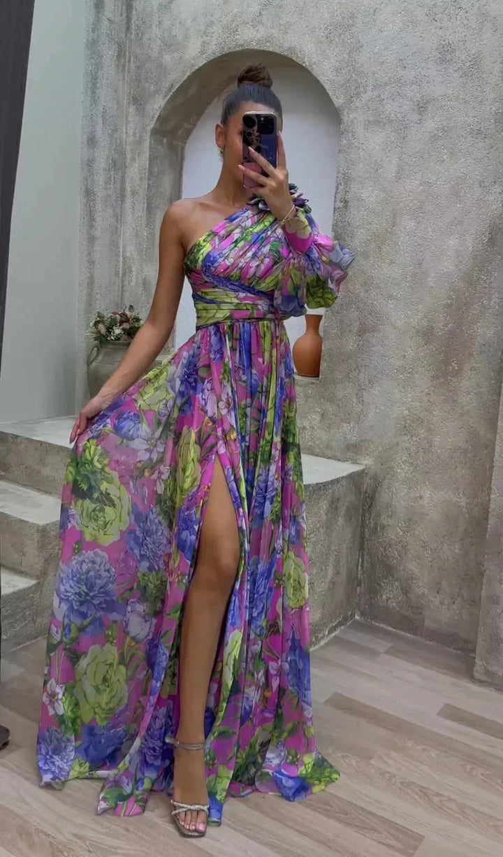 "Flowing one-shoulder floral dress in Purple, showcasing a vibrant floral pattern and a stylish asymmetrical design."