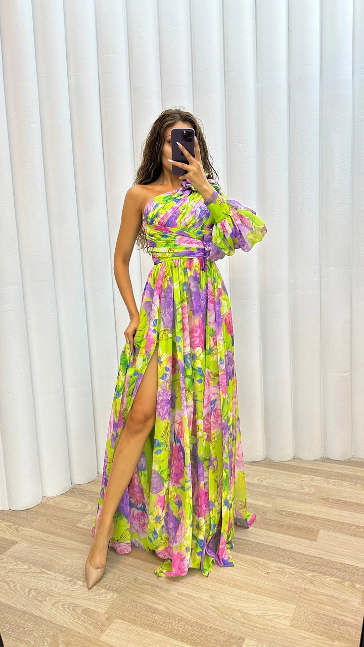 Yellow one-shoulder floral dress by Afnan, featuring a flowing design, perfect for adding a touch of elegance to any…