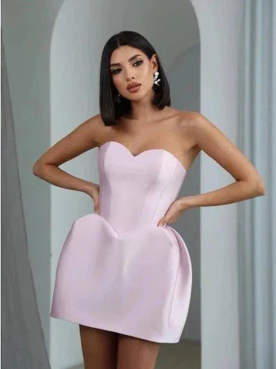 Pink strapless mini dress with balloon skirt. Made of lightweight, breathable fabric. Perfect for a summery, fun and stylish…