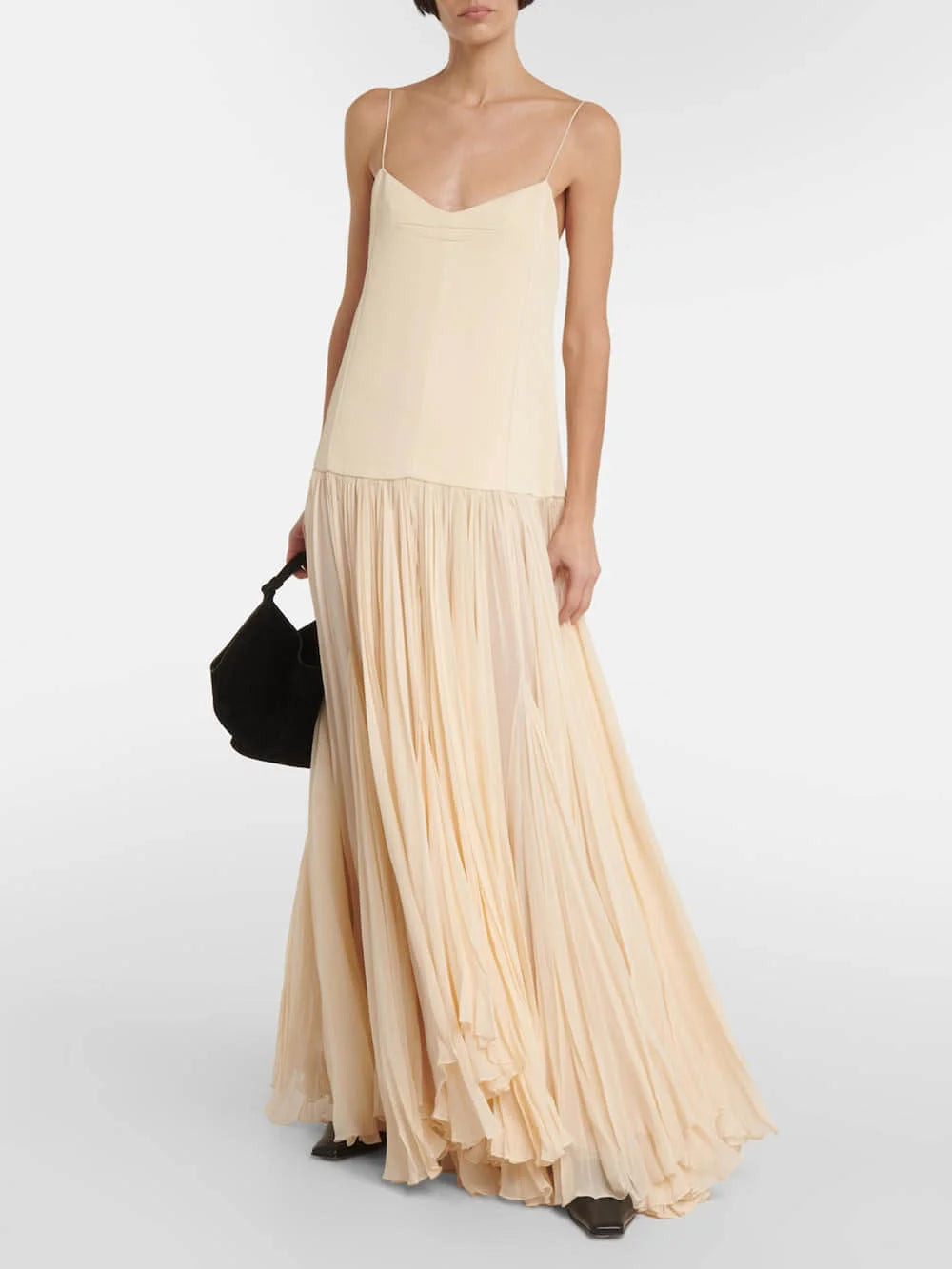 "Sleeveless ivory maxi dress featuring pleated design, crafted from lightweight fabric. Perfect for a chic and elegant look."