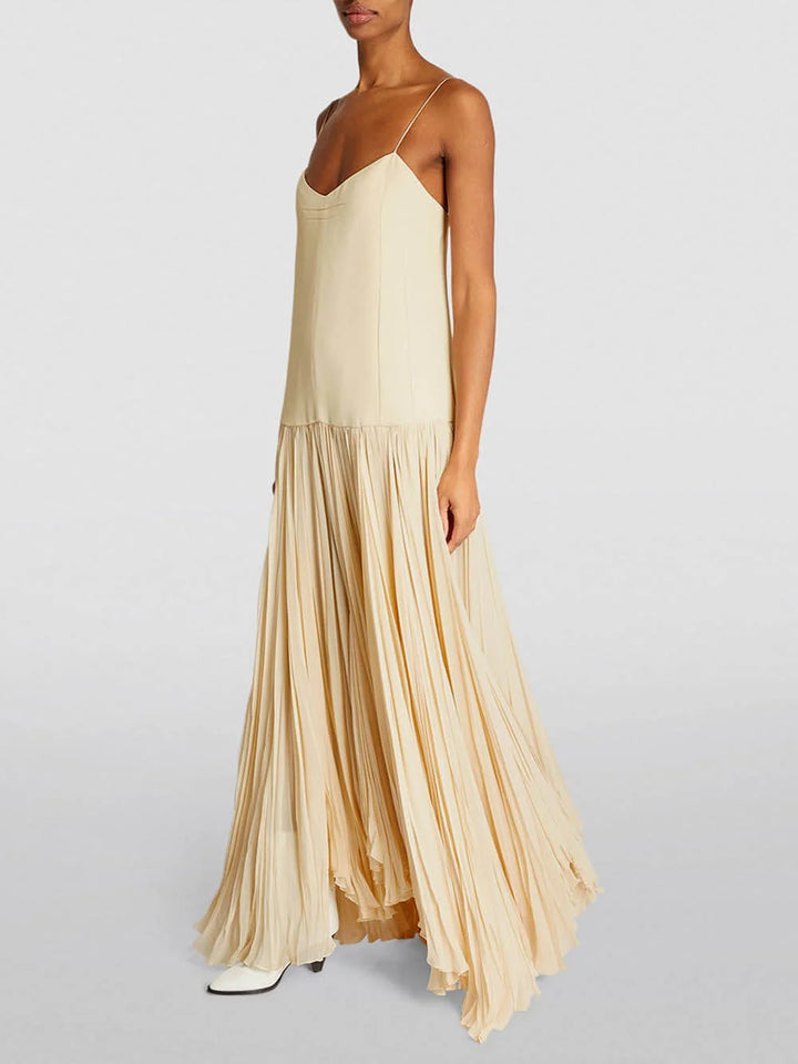 "Sleeveless ivory pleated maxi dress with a flowing silhouette, perfect for summer outings and special occasions."