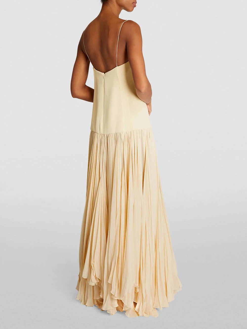 Sleeveless ivory pleated maxi dress with a flattering A-line silhouette and elegant design.