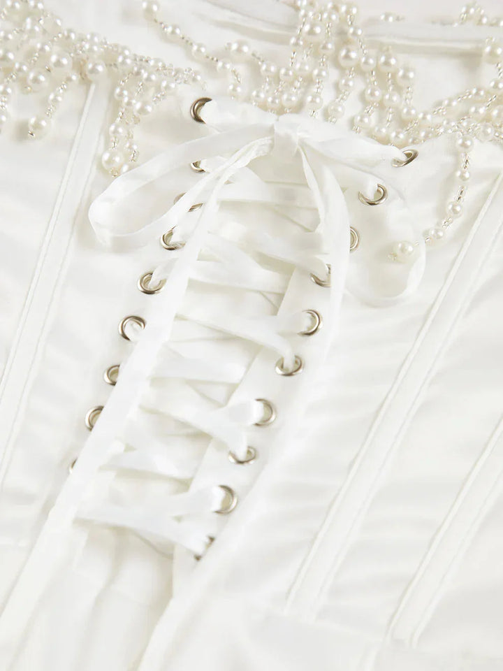 "Ivory strapless midi dress with intricate bead detailing, perfect for elegant occasions"