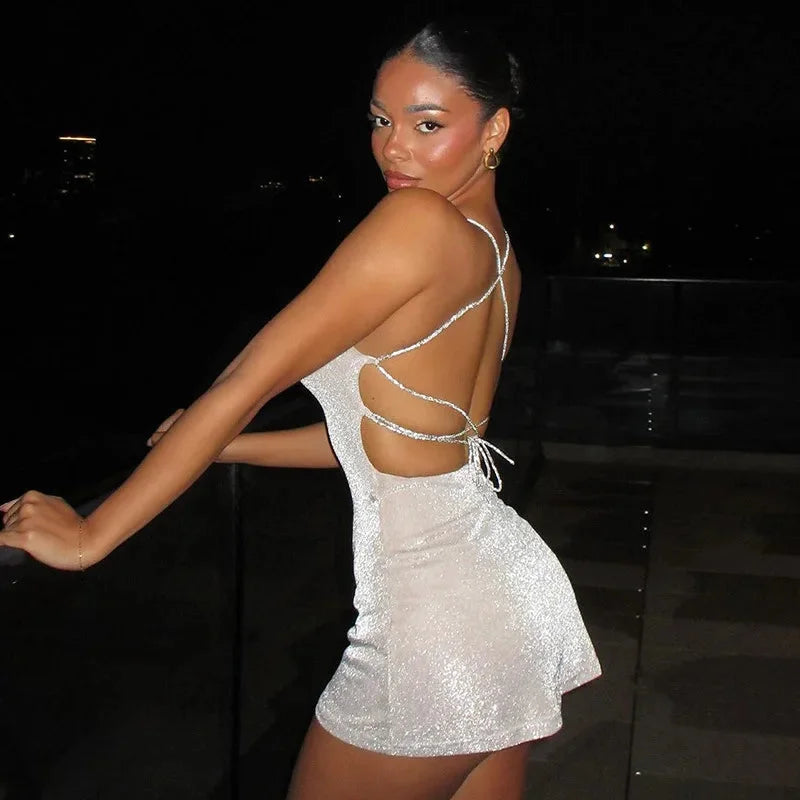 Black mini dress with sequin embellishments, open back, and flattering silhouette for a chic evening look.