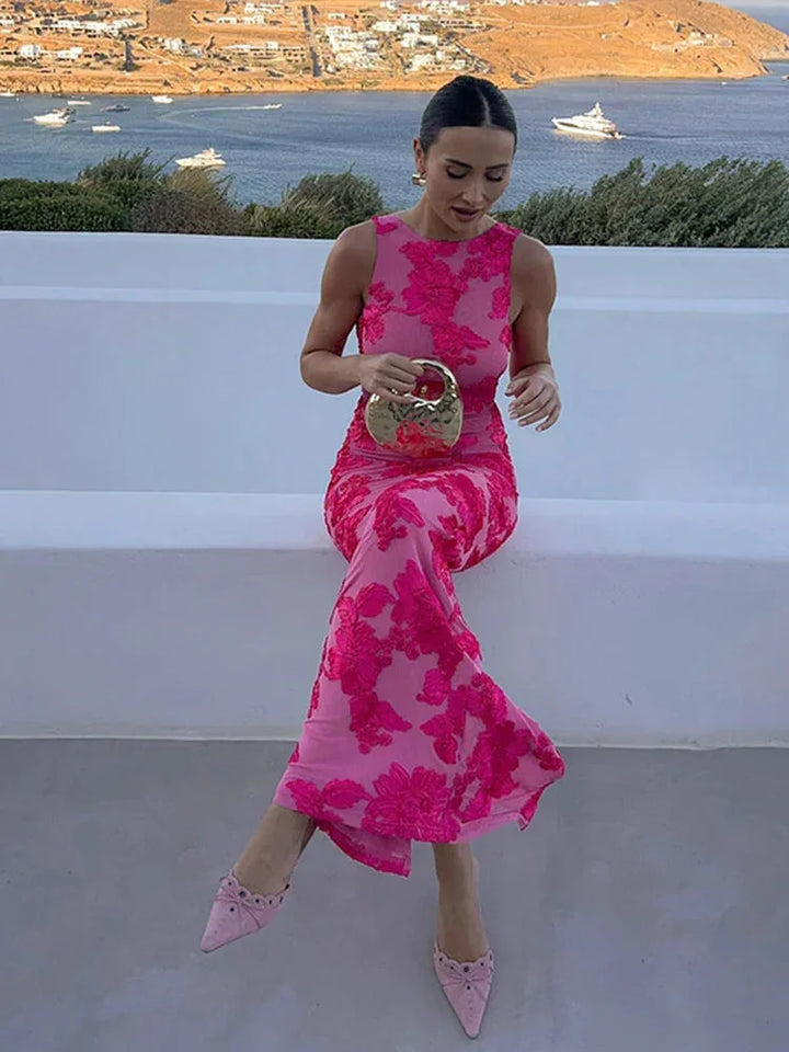 Pink sleeveless maxi dress with delicate floral pattern. Lightweight and airy fabric, perfect for warm weather outings.