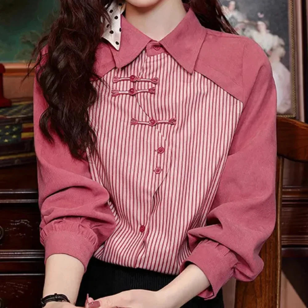 Pink striped blouse with contrast details, perfect for a chic look. Made of soft and breathable fabric with delicate accents.