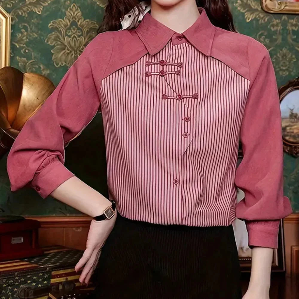 Pink striped blouse with contrast details, made of soft cotton blend. Features a rounded neckline and relaxed fit for a…