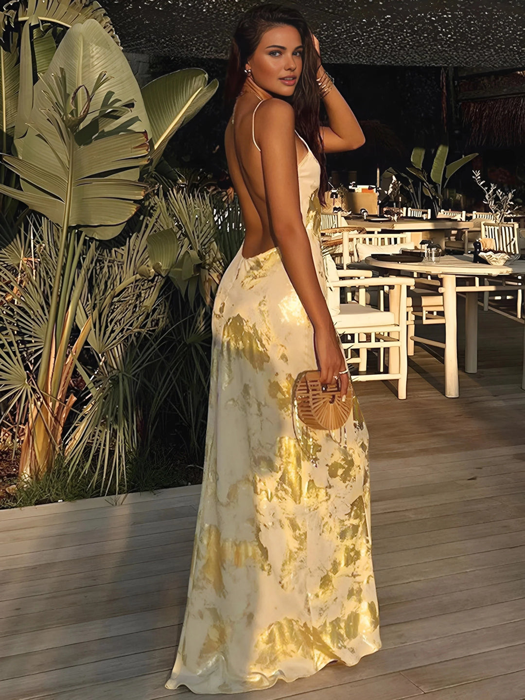 Gold foil satin maxi dress with thin straps, a glamorous choice for special occasions.