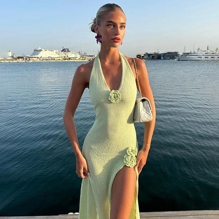 Green halter neck maxi dress with floral appliqué, perfect for a chic summer look.