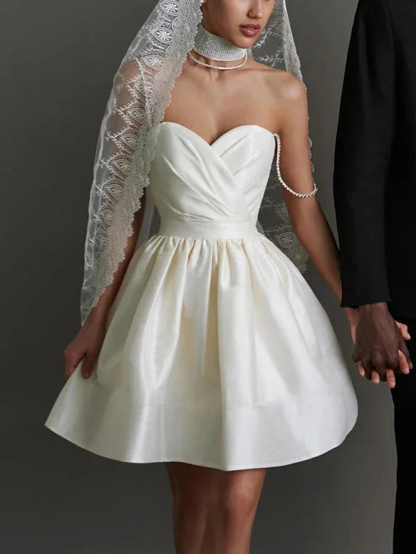 Satin mini dress featuring rhinestone strap detailing, perfect for a special event or night out.