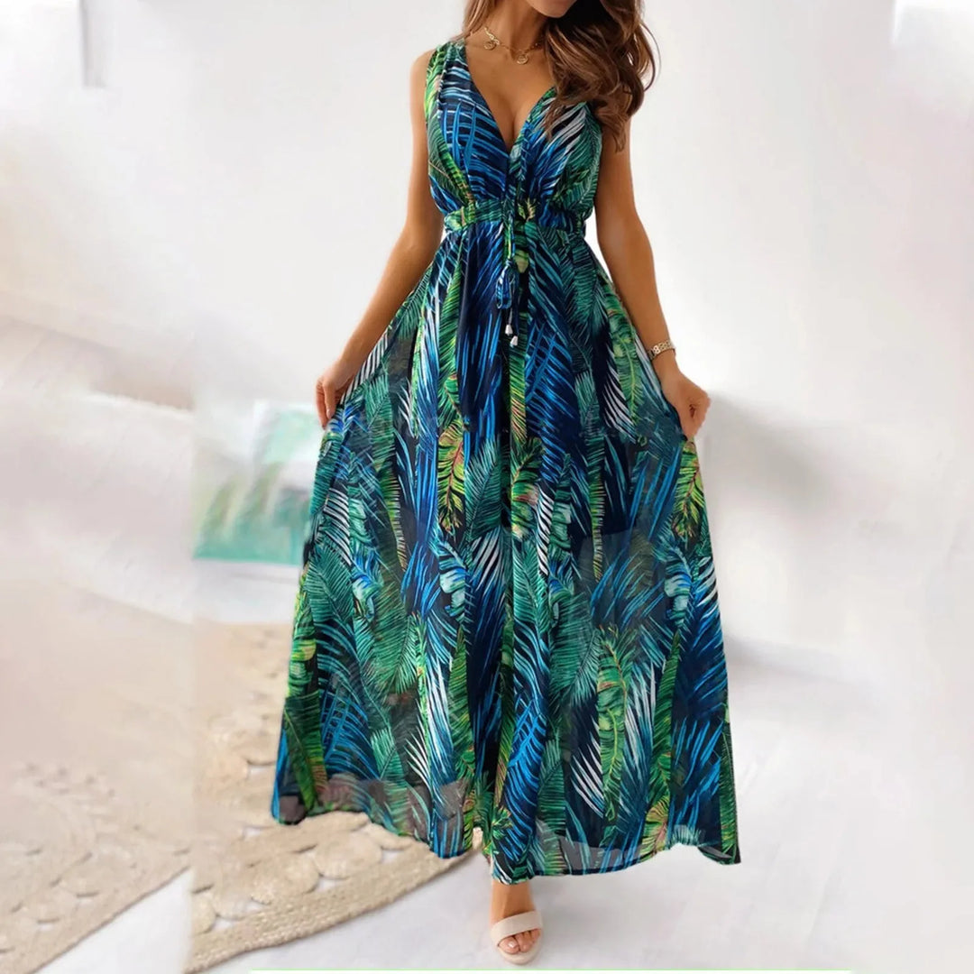 "Green floral maxi dress with sleeveless design, featuring a flowy silhouette and intricate floral pattern."