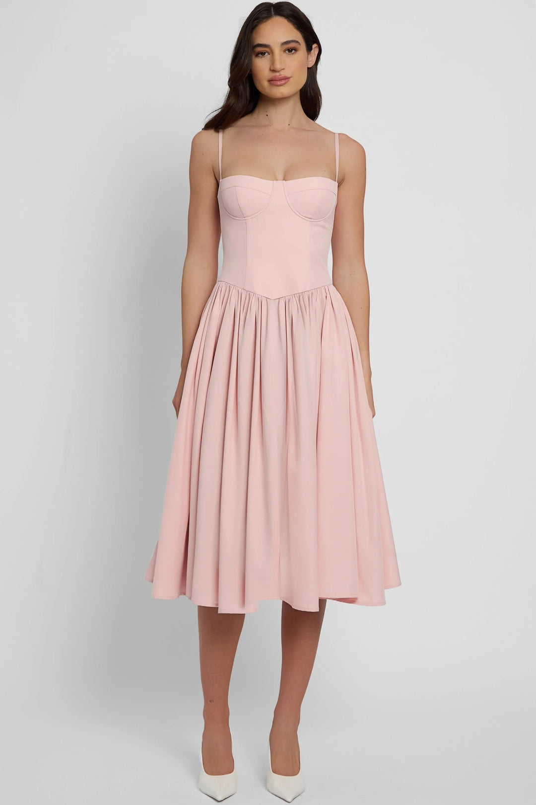 Pink bustier midi dress with flared skirt, perfect for special occasions. Made with soft and flowy fabric, features a…