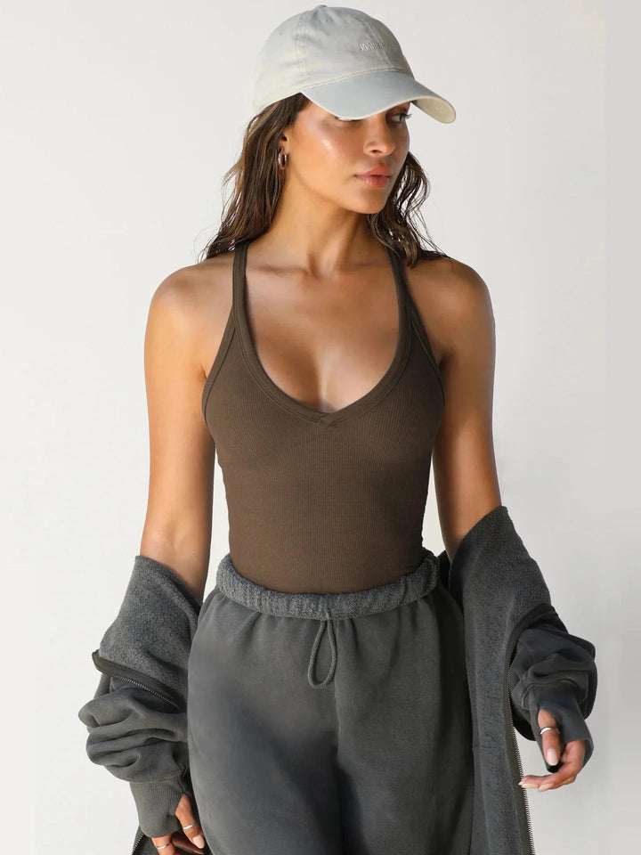 "Black seamless tank top with racerback design for active wear, made from moisture-wicking fabric."