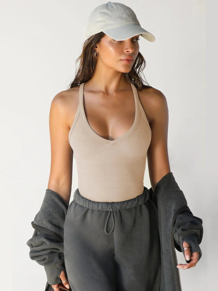 "Navy blue seamless athletic tank top for active wear, featuring moisture-wicking fabric and a racerback design."
