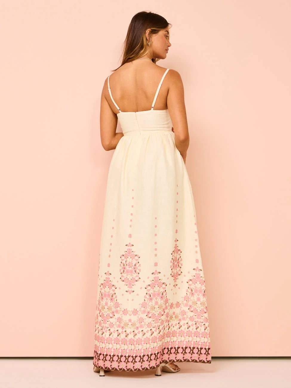 Cream maxi dress with intricate floral embroidery, perfect for summer days.