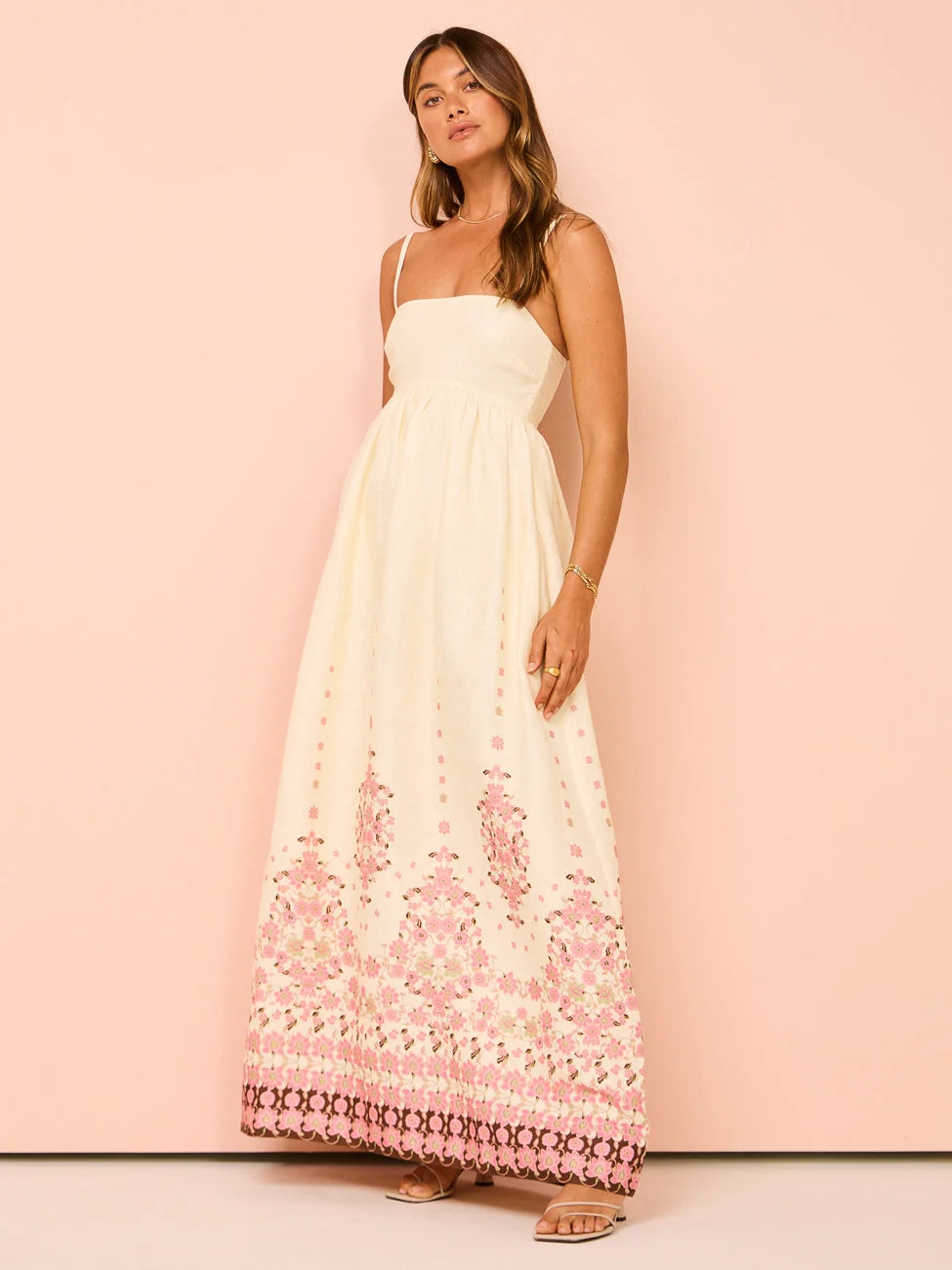 Cream maxi dress with intricate floral embroidery design on sheer fabric overlay. Perfect for a breezy summer day or special…