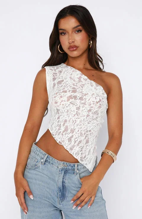 White halter top showcasing delicate lace texture, perfect for a chic and elegant look.